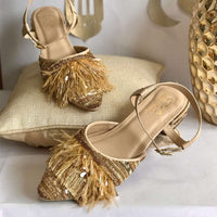 Stylish party wear ankle tie golden block heels ornamented with ostrich feathers, crystals, beads and a variety of sequin.