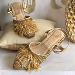 Stylish party wear ankle tie golden block heels ornamented with ostrich feathers, crystals, beads and a variety of sequin.