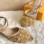 Stylish party wear ankle tie golden block heels ornamented with ostrich feathers, crystals, beads and a variety of sequin.