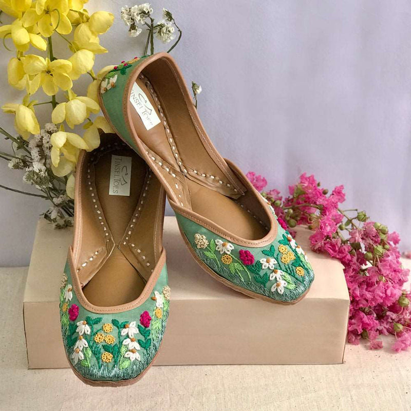 Ethnic handcrafted hand-embroidered green juttis with beautiful thread work flowers for women.