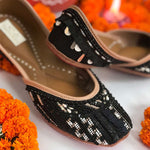 Ethnic black juttis embroidered with katdana, beads and unique sequins handcrafted for women.