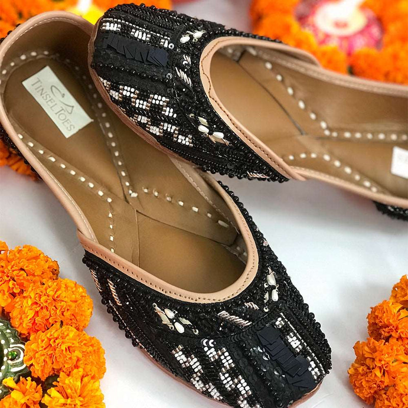 Ethnic black juttis embroidered with katdana, beads and unique sequins handcrafted for women.