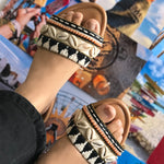 Handcrafted monochrome bohemian trendy and stylish sliders decorated and embellished with sea shells, beads and thread work.