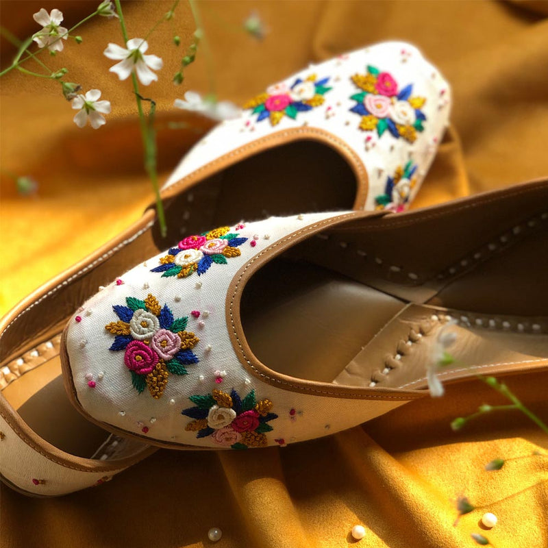 Handcrafted beautiful lustrous white juttis embroidered with bullion and french knots for women.