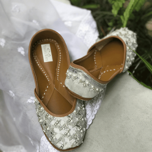 Ethnic handcrafted hand-embroidered silver juttis beautifully embroidered with crystals, katdana, pearls, zari, mukaish embroidery and sequins for women.