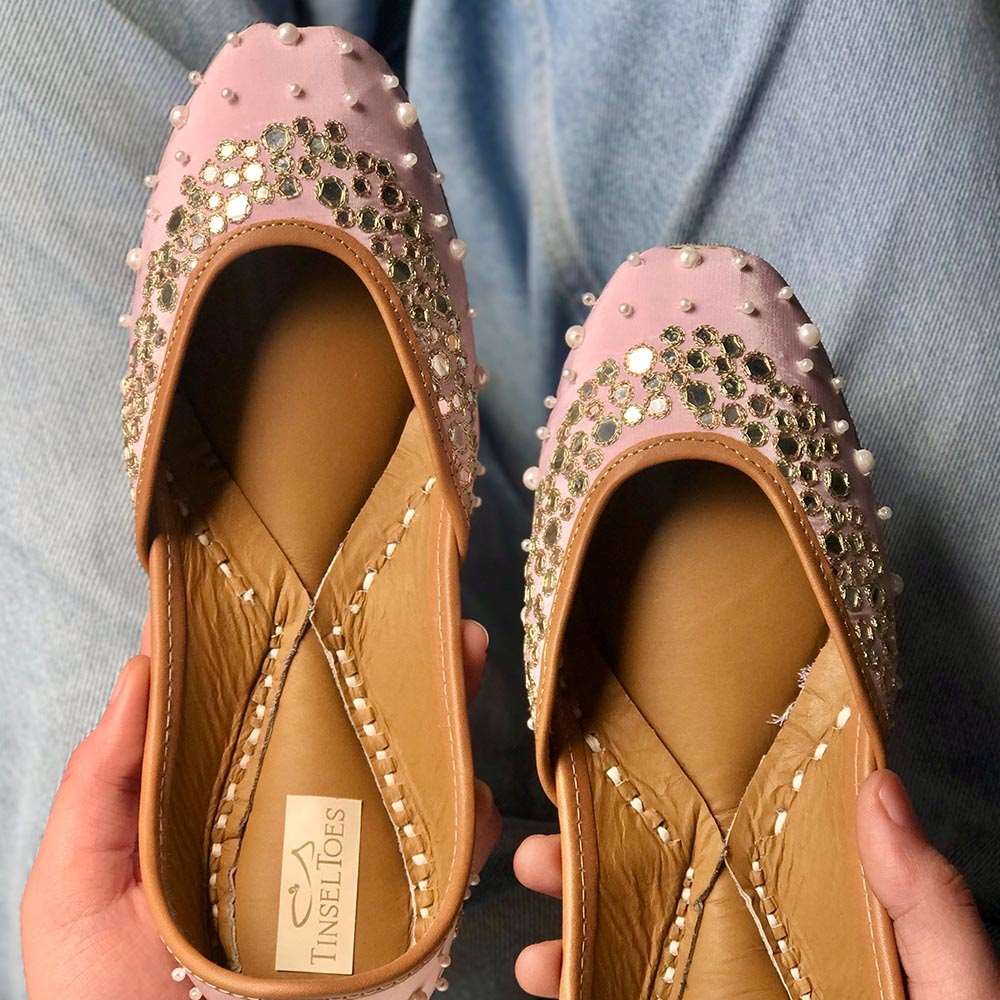 Ethnic handcrafted hand-embroidered nude pink juttis delicately embroidered with pearls, zari and mirrors for women.